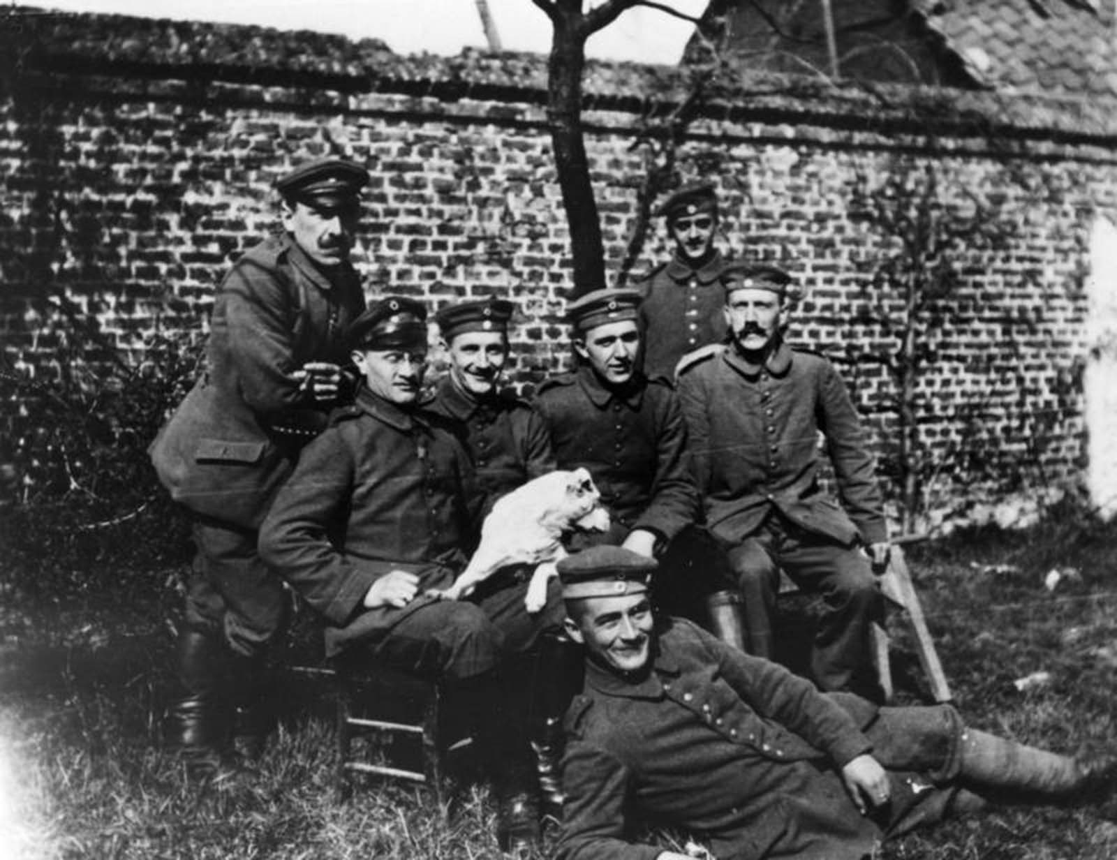 Hitler sitting at far right among soldiers of the 