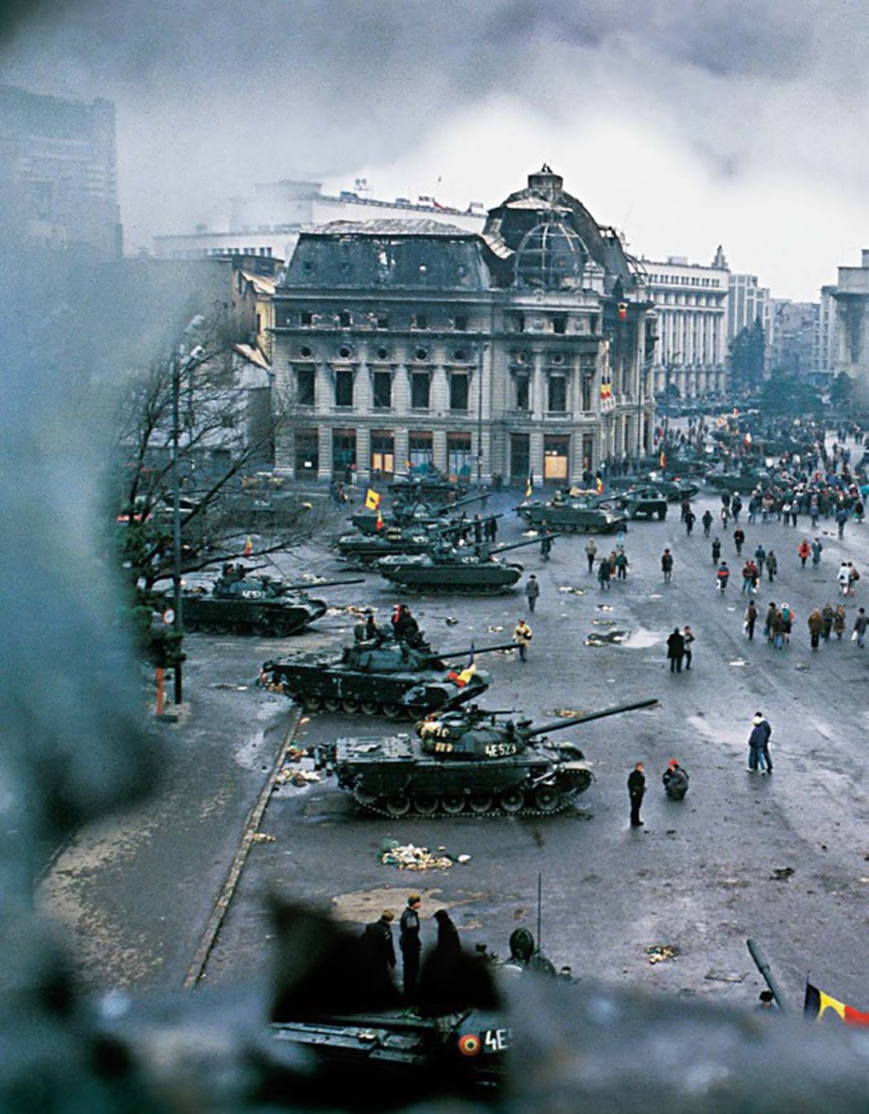 View of tanks and damaged buildings in Bucharest's central square at the conclusion of the Romanian Revolution.