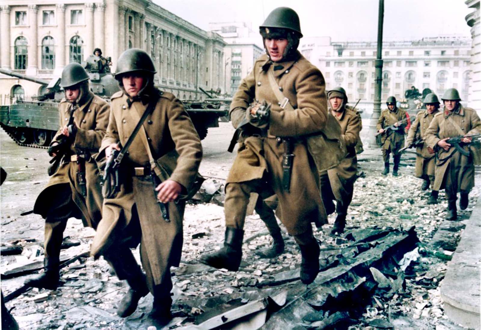 Soldiers run for cover during crossfire between pro-Ceaucescu troops and anti-regime supporters near the Republican square in Bucharest. 