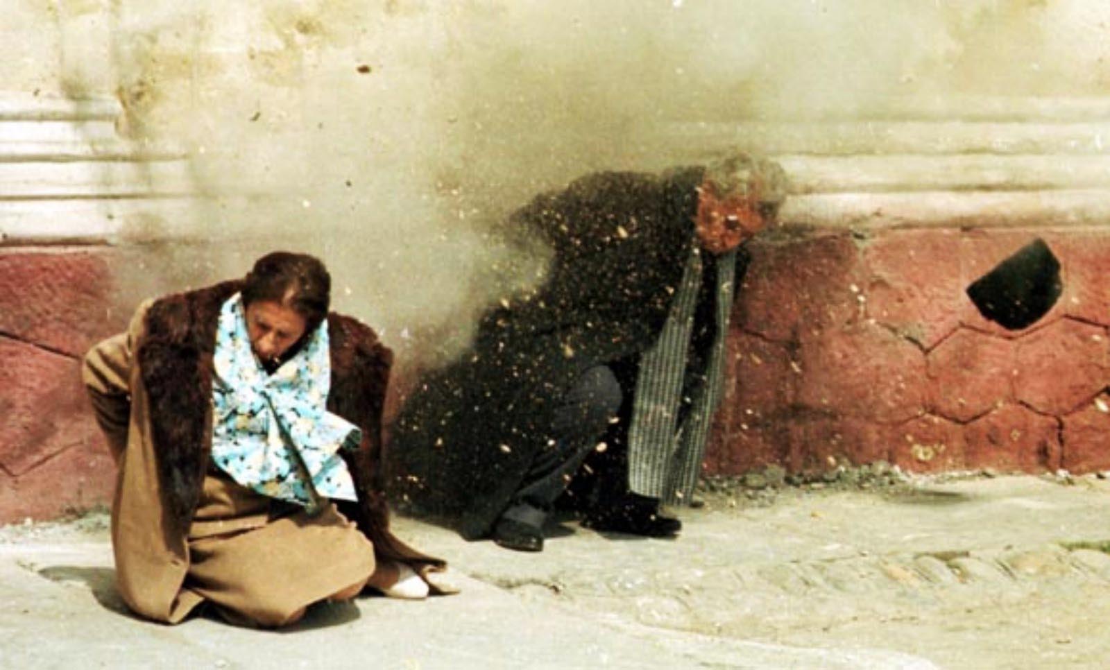 The Ceausescus were placed against a wall and, before they could be blindfolded, shot multiple times by three soldiers. 
