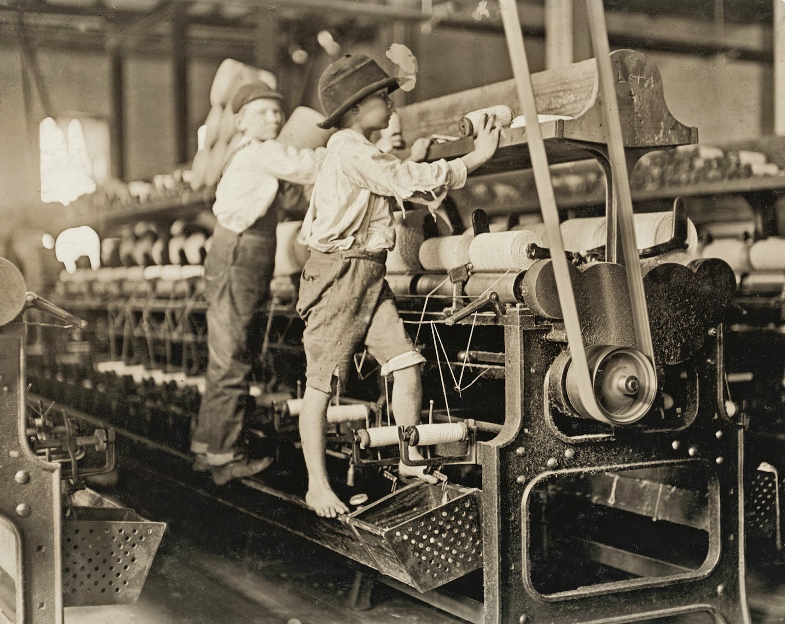 The Mill: Some boys and girls were so small they had to climb up on to the spinning frame to mend broken threads and to put back the empty bobbins. Bibb Mill No. 1. Macon, Georgia.