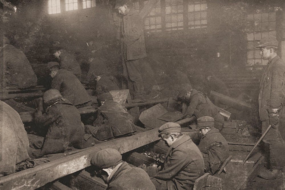 Miners: View of the Ewen Breaker of the Pennsylvania Coal Co. The dust was so dense at times as to obscure the view. This dust penetrated the utmost recesses of the boys' lungs. A kind of slave-driver sometimes stands over the boys, prodding or kicking them into obedience. South Pittston, Pennsylvania