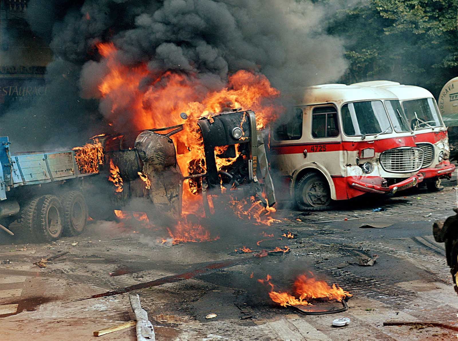 A barricade made from trucks and buses burns in front of the Czechoslovak Radio building, in central Prague, on August 21, 1968.