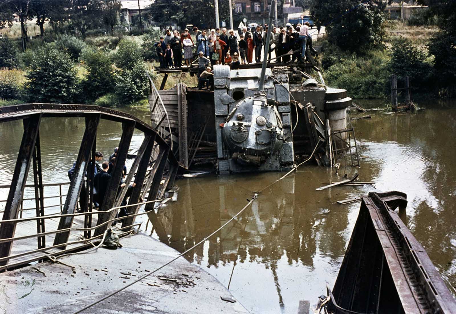 A Soviet tank is out of action after a bridge it was crossing gave way on August 21, 1968. One witness said the bridge had been dynamited, but the span may have collapsed due to the heavy weight of the tanks crossing it.