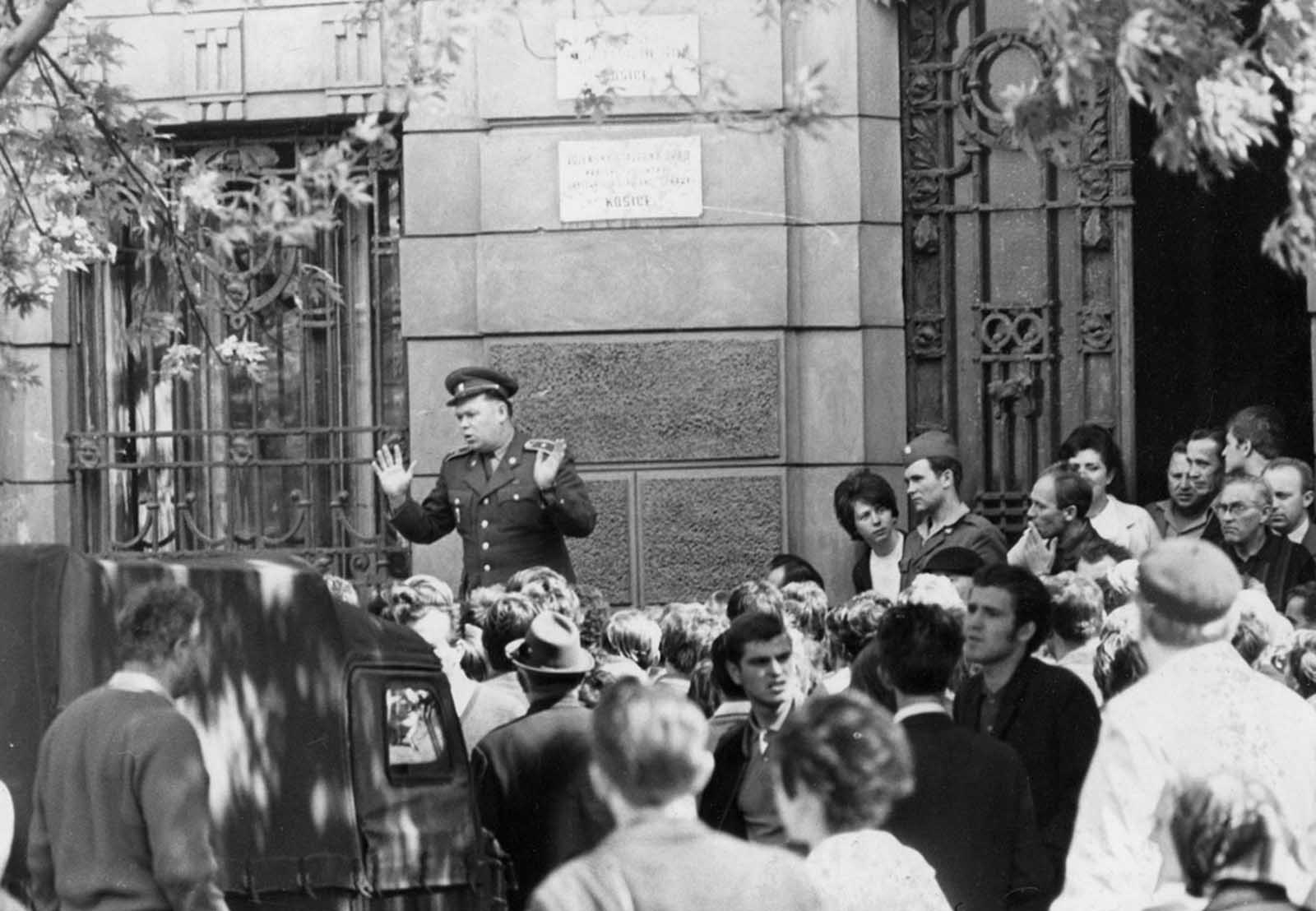 A member of the Czechoslovakian army is jeered by locals in Košice, Czechoslovakia, on August 21, 1968, as he addresses them outside the city hall shortly after troops had occupied the town as part of the Soviet invasion.