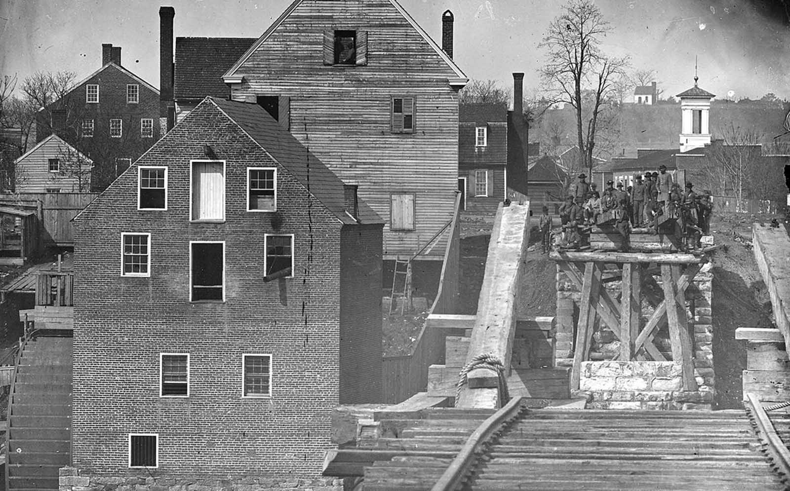 Confederate troops viewed from a distance of one mile, on the opposite side of a destroyed bridge in Fredericksburg, Virginia, by Union photographer Mathew Brady.