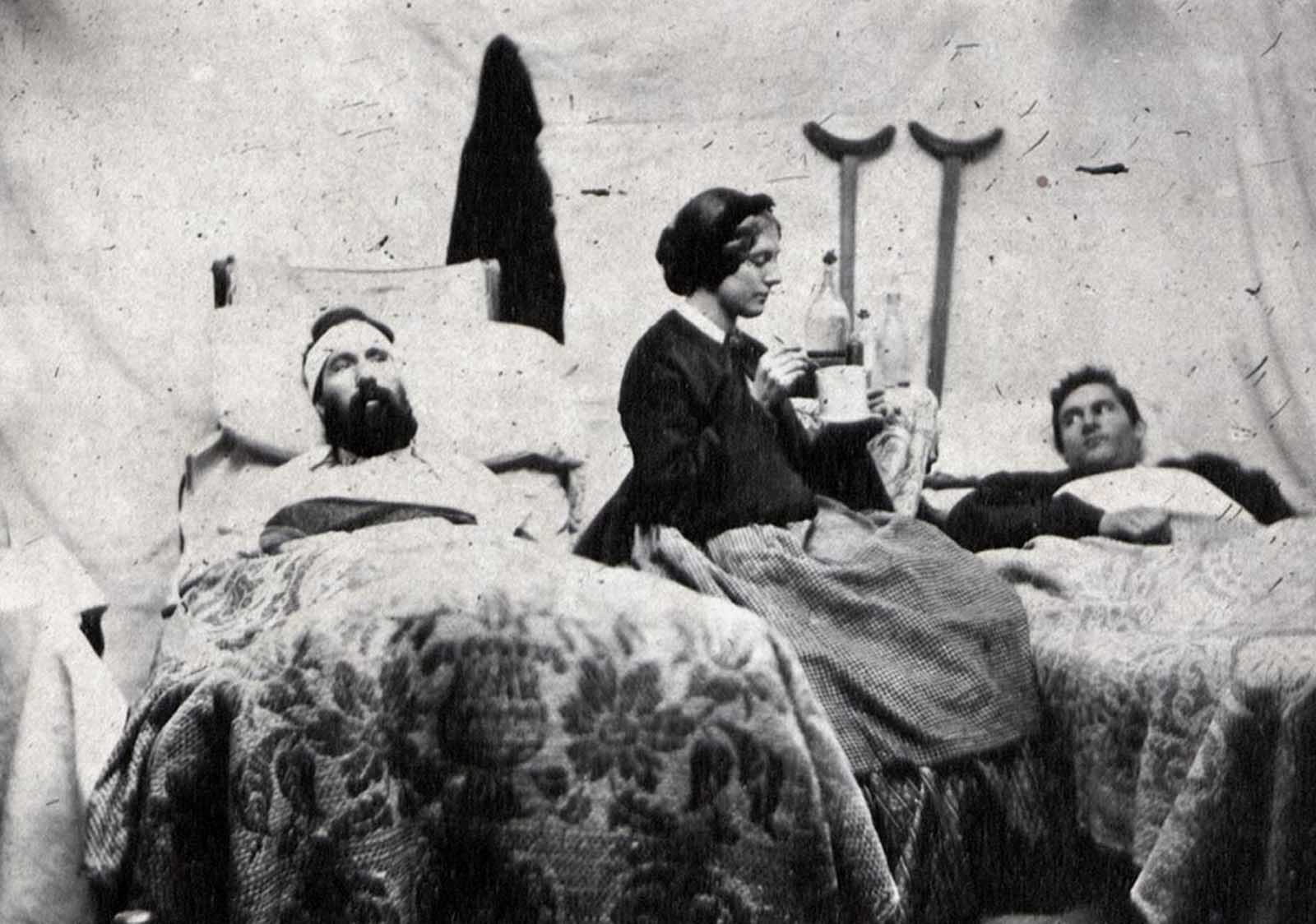 Nurse Anne Bell tending to wounded soldiers in a Union hospital, ca. 1863.