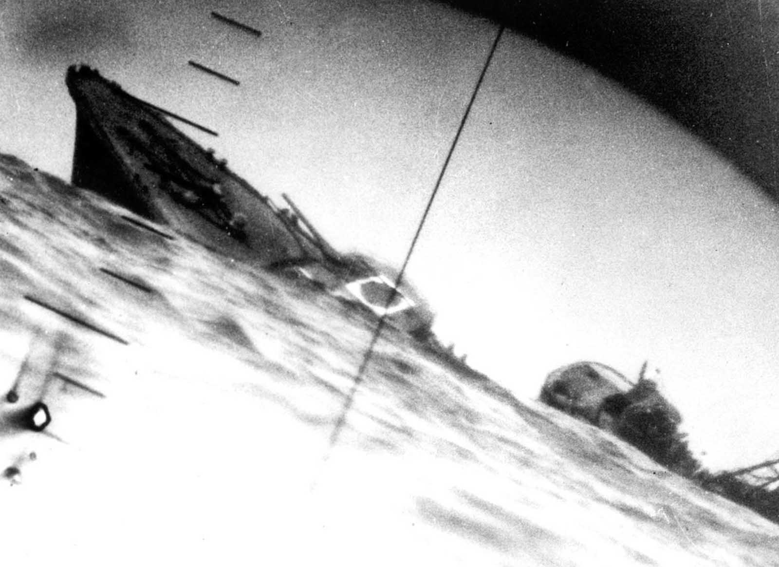 Torpedoed Japanese destroyer Yamakaze, photographed through periscope of USS Nautilus, 25 June 1942. The Yamakaze sank within five minutes of being struck, there were no survivors.