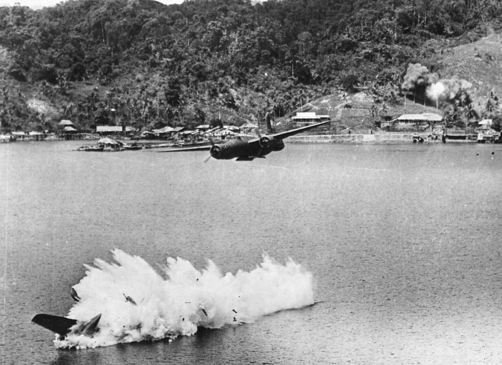 Two of twelve U.S. A-20 Havoc light bombers on a mission against Kokas, Indonesia in July of 1943. The lower bomber was hit by anti-aircraft fire after dropping its bombs, and plunged into the sea, killing both crew members.