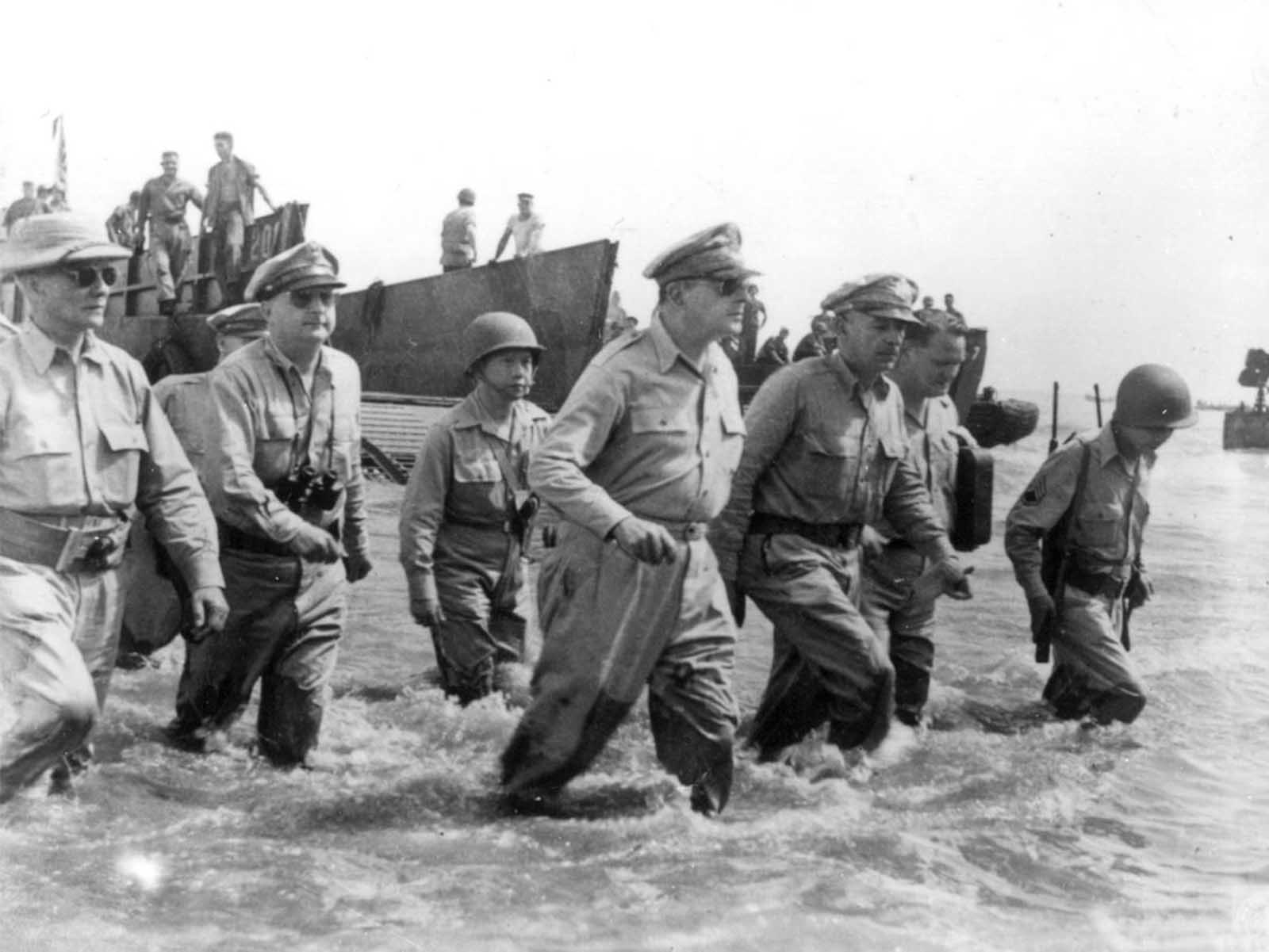 Gen. Douglas MacArthur, center, is accompanied by his officers and Sergio Osmena, president of the Philippines in exile, extreme left, as he wades ashore during landing operations at Leyte, Philippines, on October 20, 1944, after U.S. forces recaptured the beach of the Japanese-occupied island.