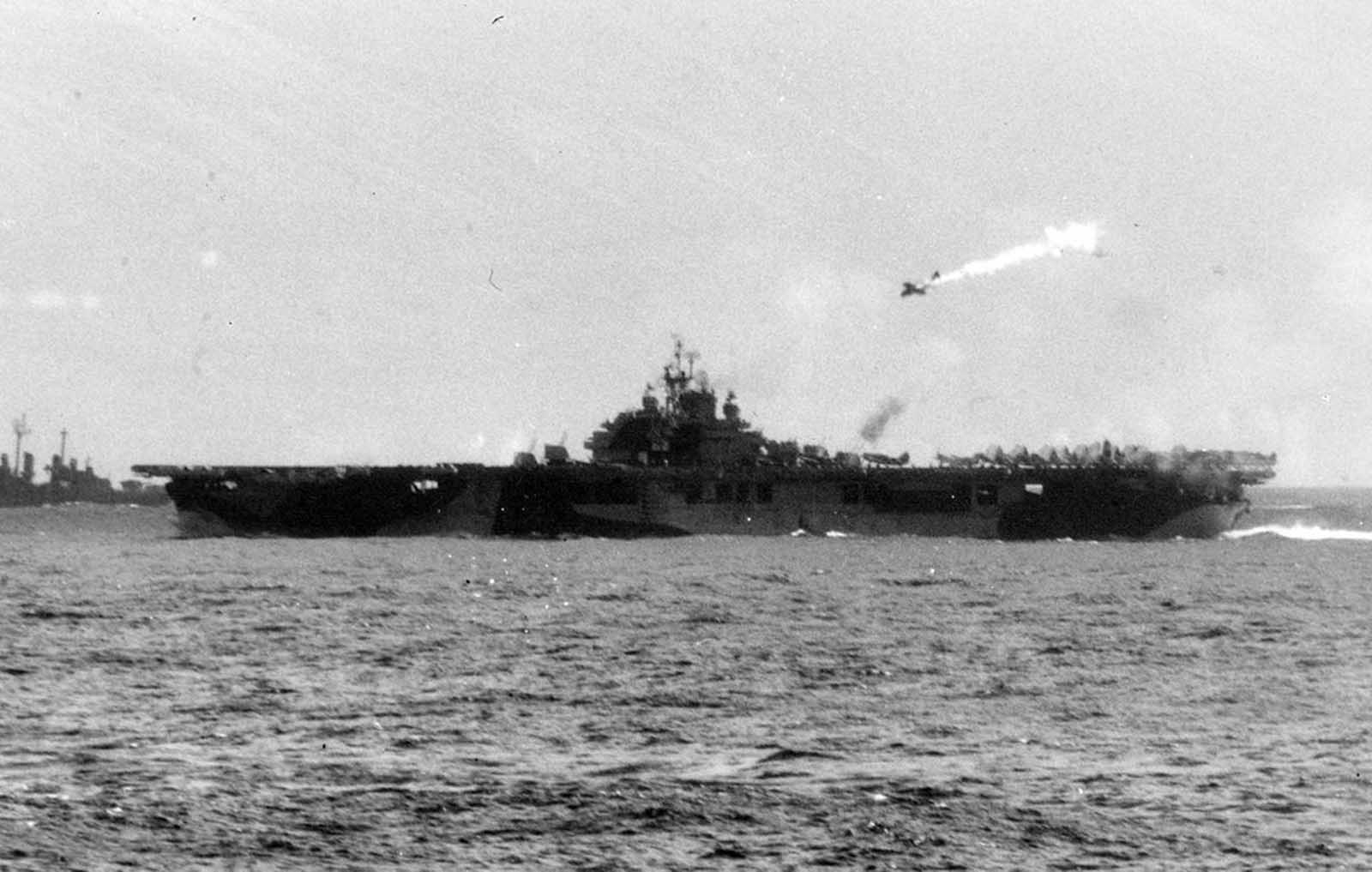 A Japanese kamikaze pilot in a damaged single-engine bomber, moments before striking the U.S. Aircraft Carrier USS Essex, off the Philippine Islands, on November 25, 1944.