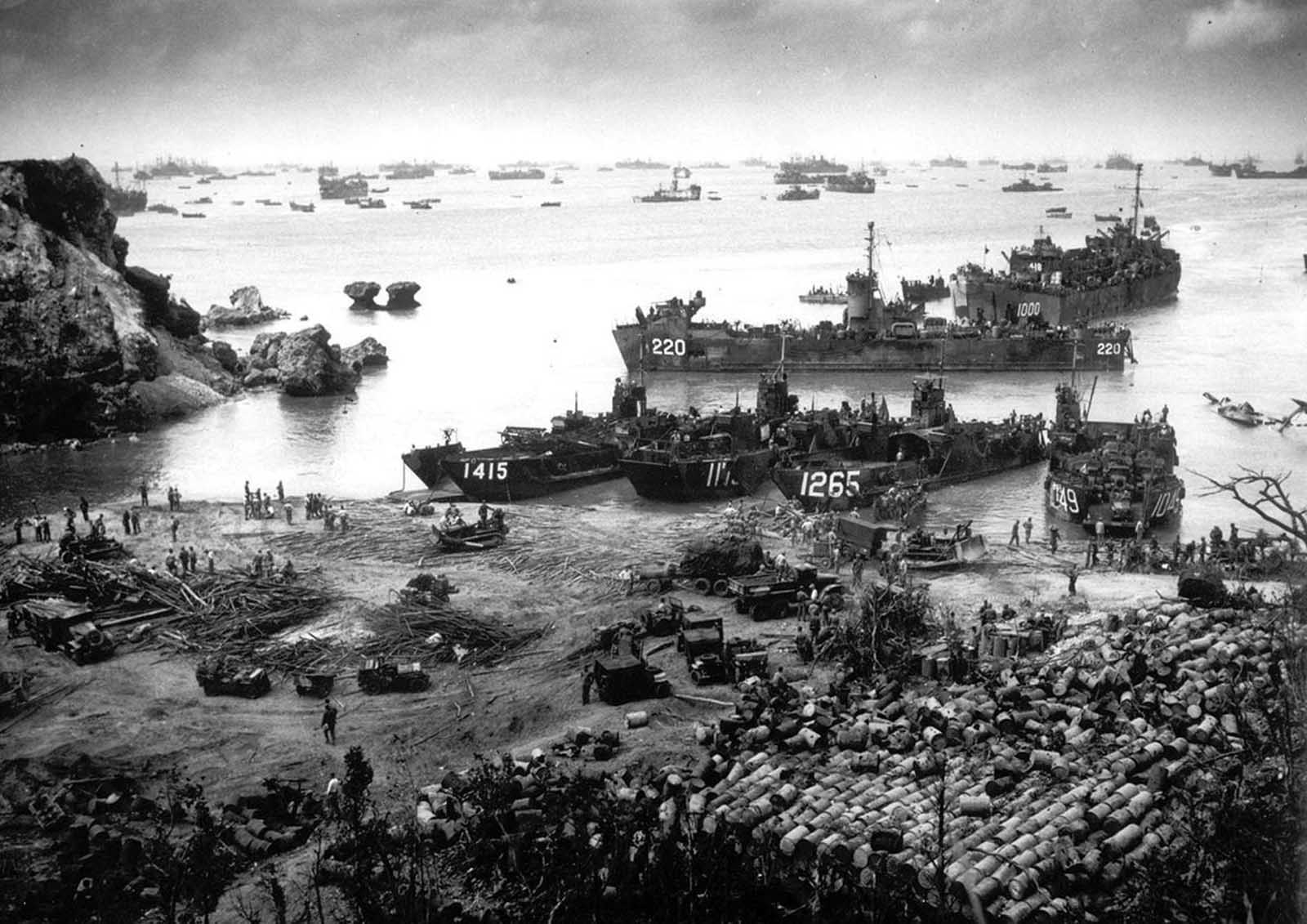 U.S. invasion forces establish a beachhead on Okinawa island, about 350 miles from the Japanese mainland, on April 13. 1945. Pouring out war supplies and military equipment, the landing crafts fill the sea to the horizon, in the distance, battleships of the U.S. fleet.