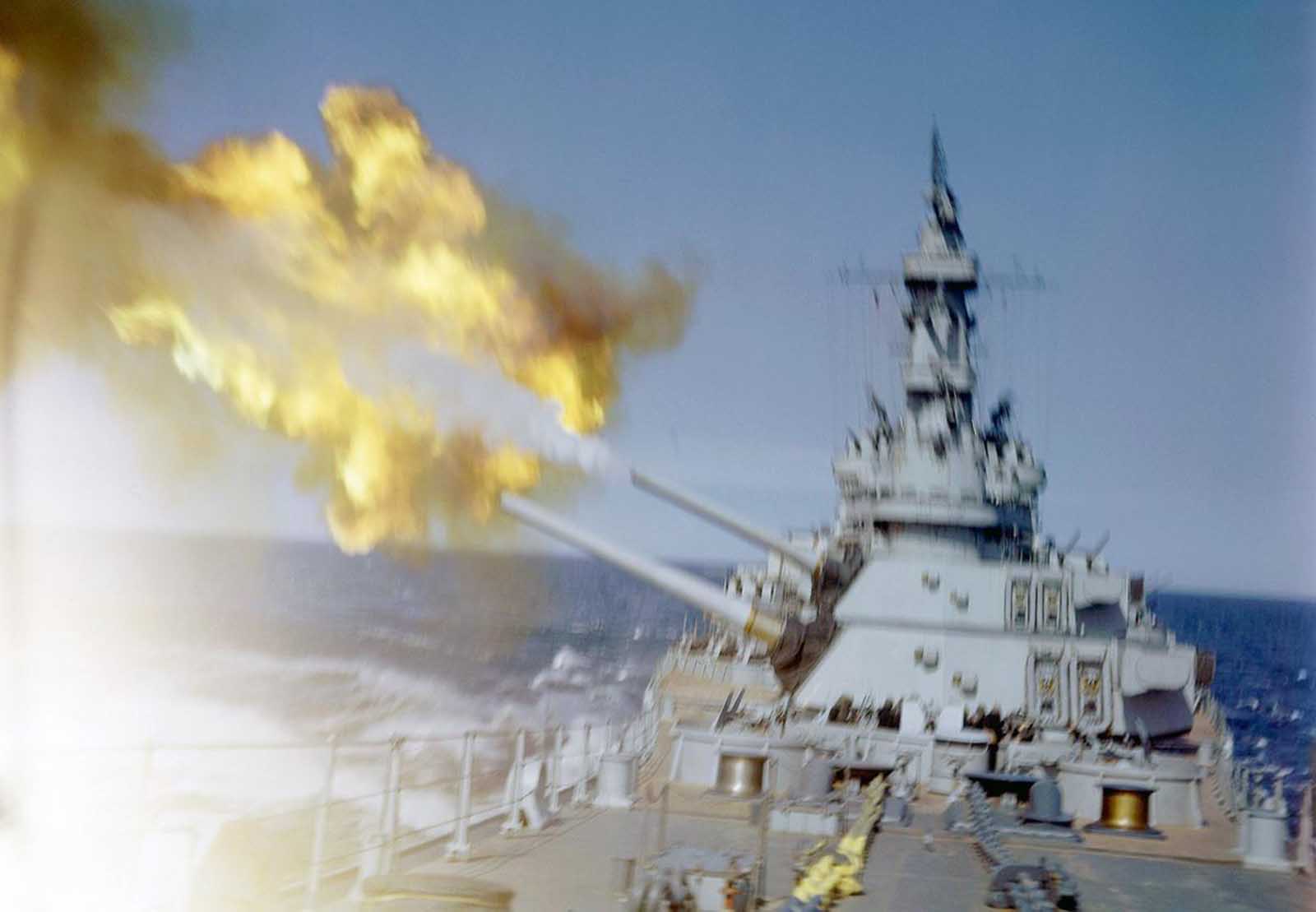 A U.S. cruiser fires her main batteries at Japanese positions on the southern tip of Okinawa, Japan in 1945.