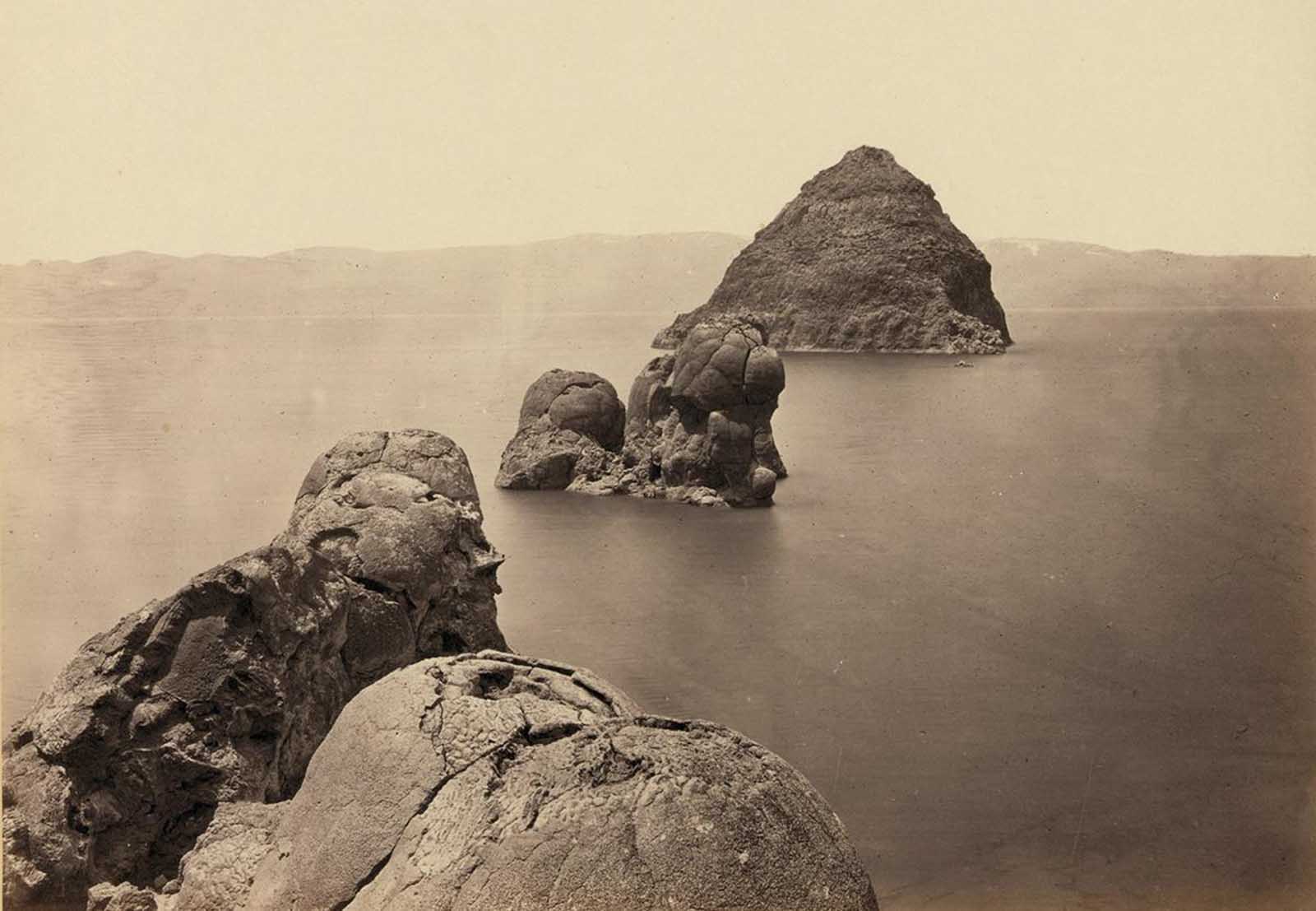 The Pyramid and Domes, a line of dome-shaped tufa rocks in Pyramid Lake, Nevada, seen in 1867.