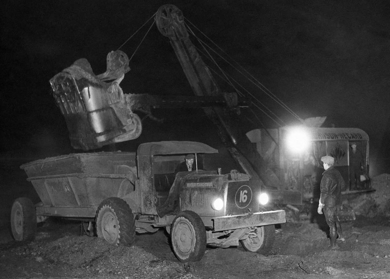 Shifts covering full 24-hour period were in effect as work was rushed on the filling in of land for the New York World's Fair in Flushing, New York, on December 16, 1936.