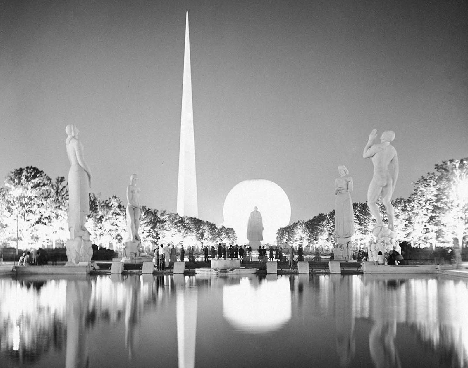 A view taken from the side of one of the many lagoons at the New York World's Fair on July 7, 1939. Light brings out some of the wondrous beauty as erected at the 