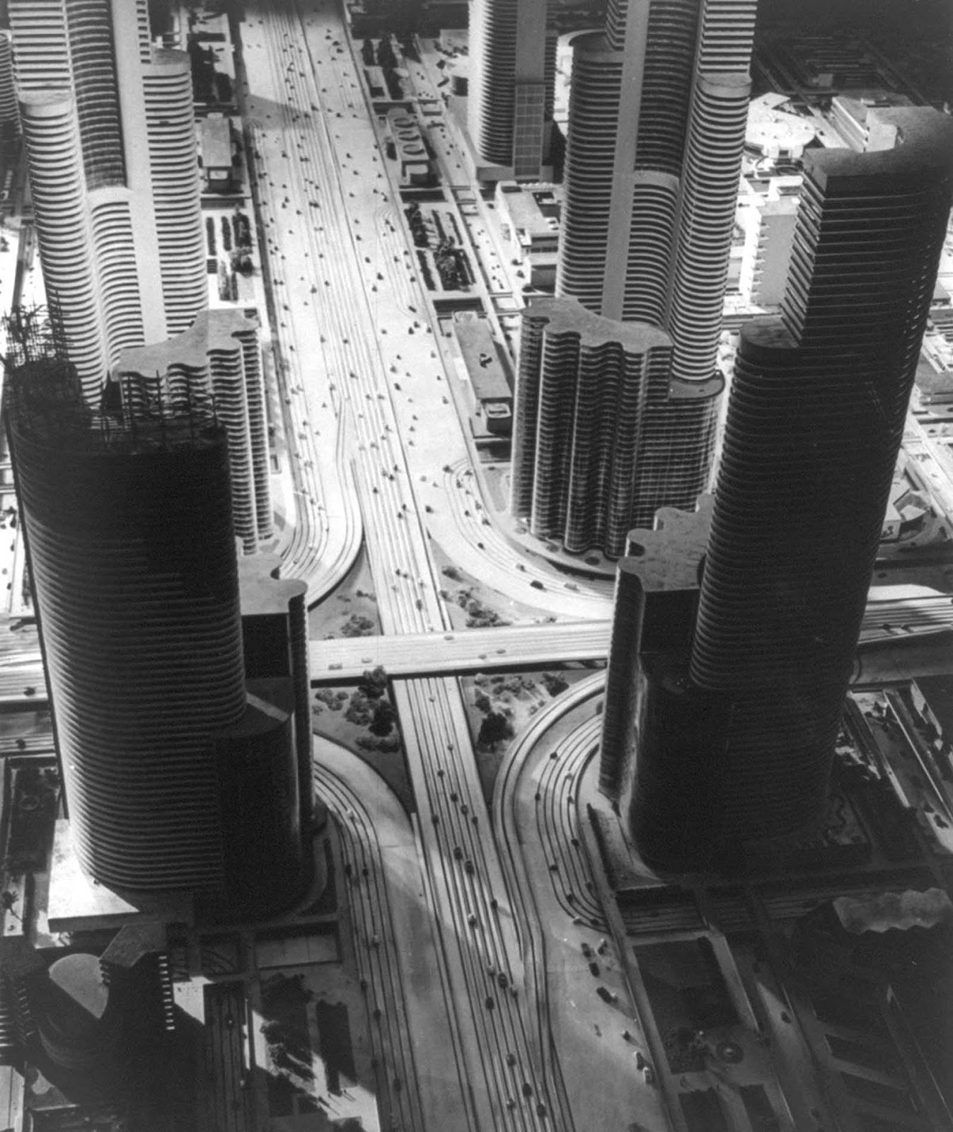 Futurama, the model city of 1960, designed by Norman Bel Geddes for the General Motors Exhibit at the New York World's Fair in 1939. This photograph shows an elevated view of the huge model of a futuristic city with widely spaced skyscrapers, double-decked streets with moving cars representing traffic patterns, and parks and landing pads for helicopters and auto-gyros shown on the roofs of low buildings.