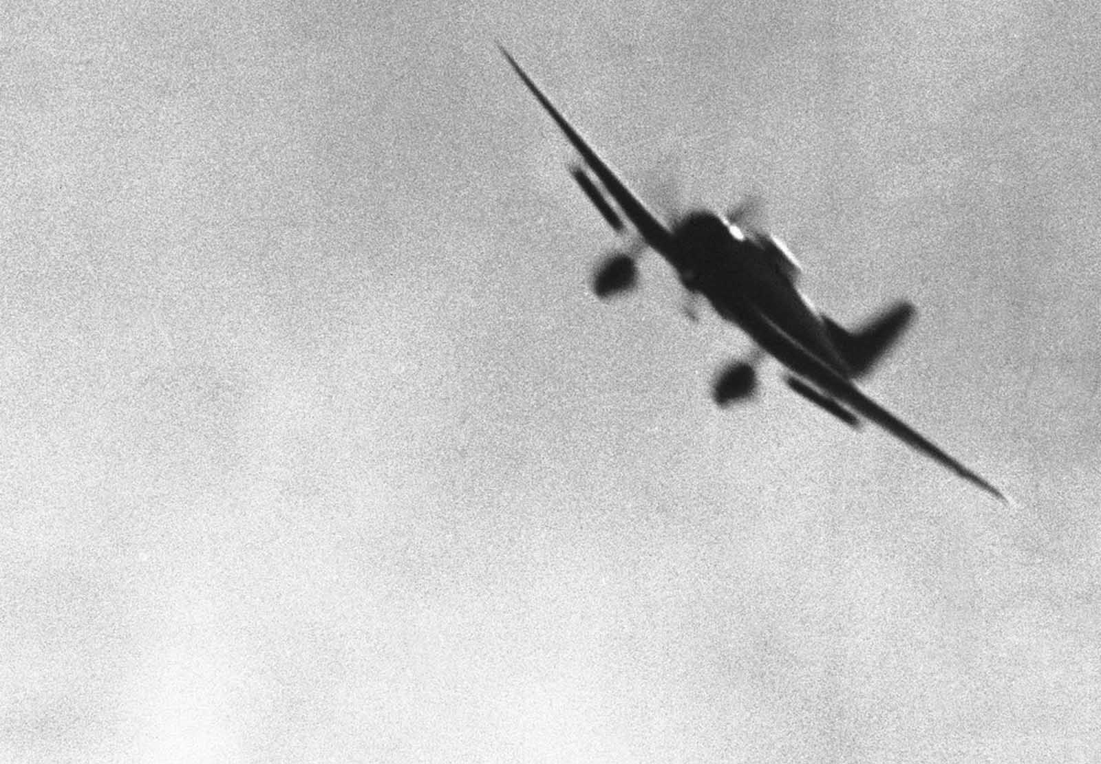 A Japanese bomber, its diving flaps down, was photographed by a U.S. Navy photographer as the plane approached its Pearl Harbor objective on December 7.