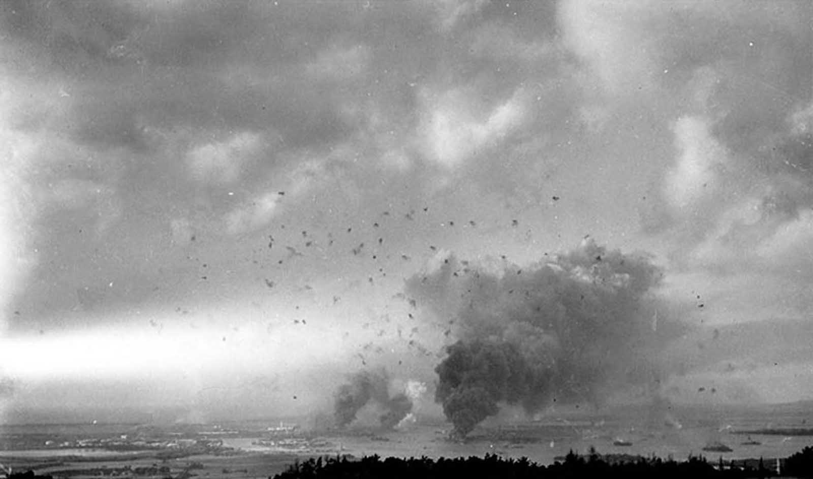 A wide-angle view of the sky above Pearl Harbor, Hawaii, filled with smoke and anti-aircraft fire on December 7, 1941.