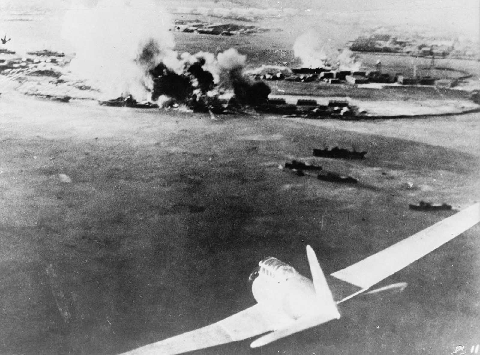 Aerial photograph, taken by a Japanese pilot, of the attack on Pearl Harbor, a Japanese bomber in lower-right foreground.