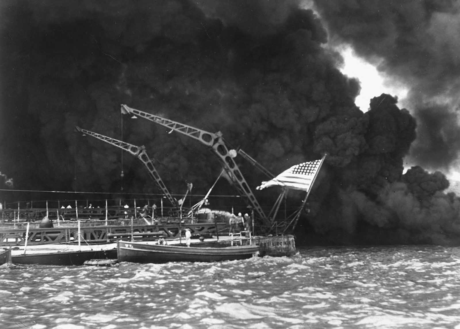 A U.S. flag flies from the stern of the sunken battleship USS West Virginia after the Japanese attack on Pearl Harbor, December 7, 1941.