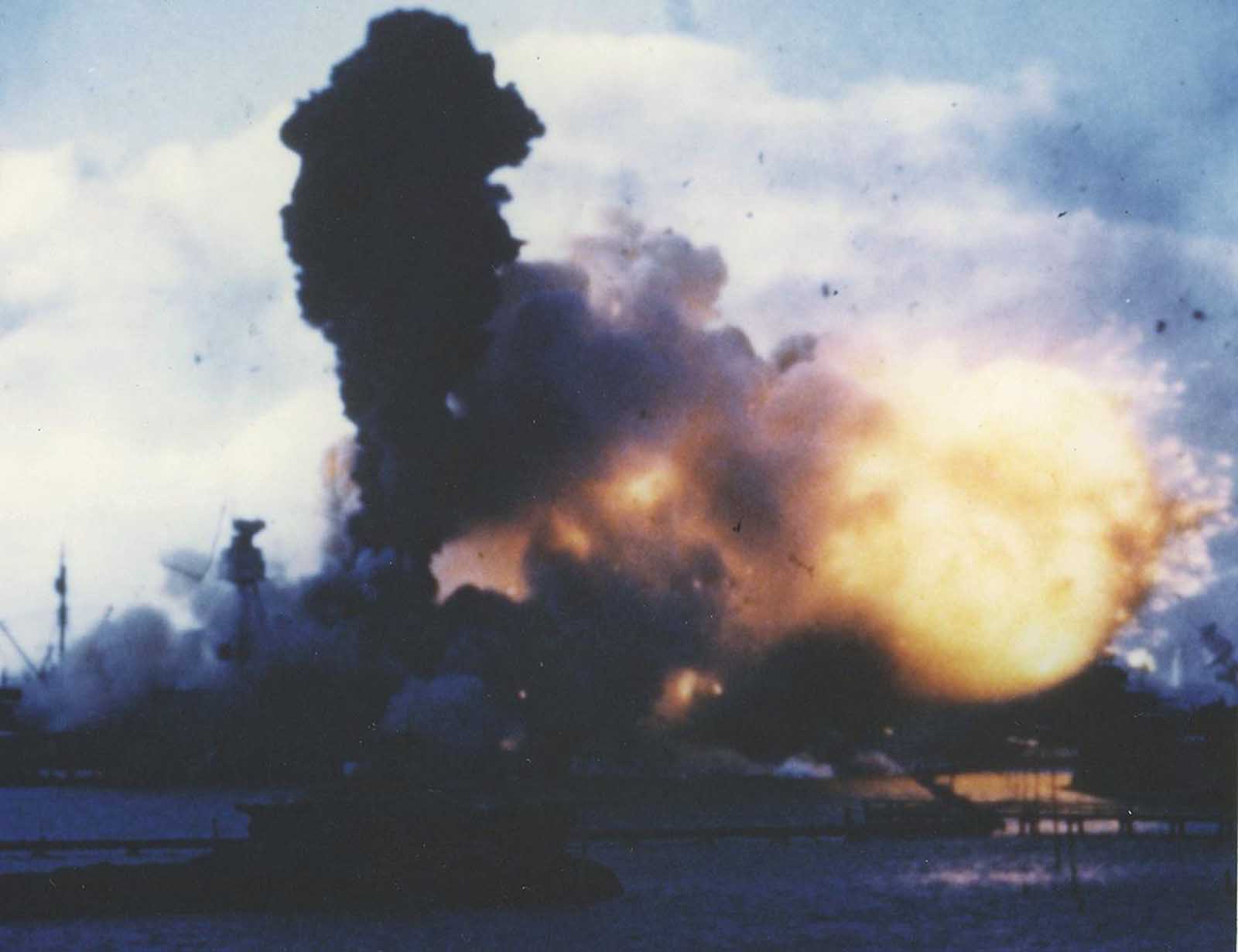 The forward magazines of USS Arizona explode after she was hit by a Japanese bomb on December 7, 1941. Frame clipped from a color motion picture taken from on board USS Solace.