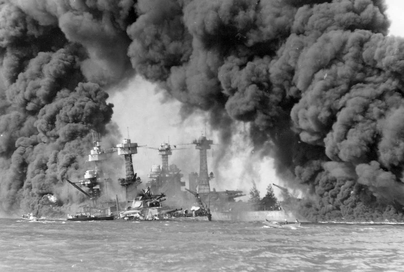 The battleships West Virginia and Tennessee burning after the Japanese attack on Pearl Harbor, on December 7, 1941.
