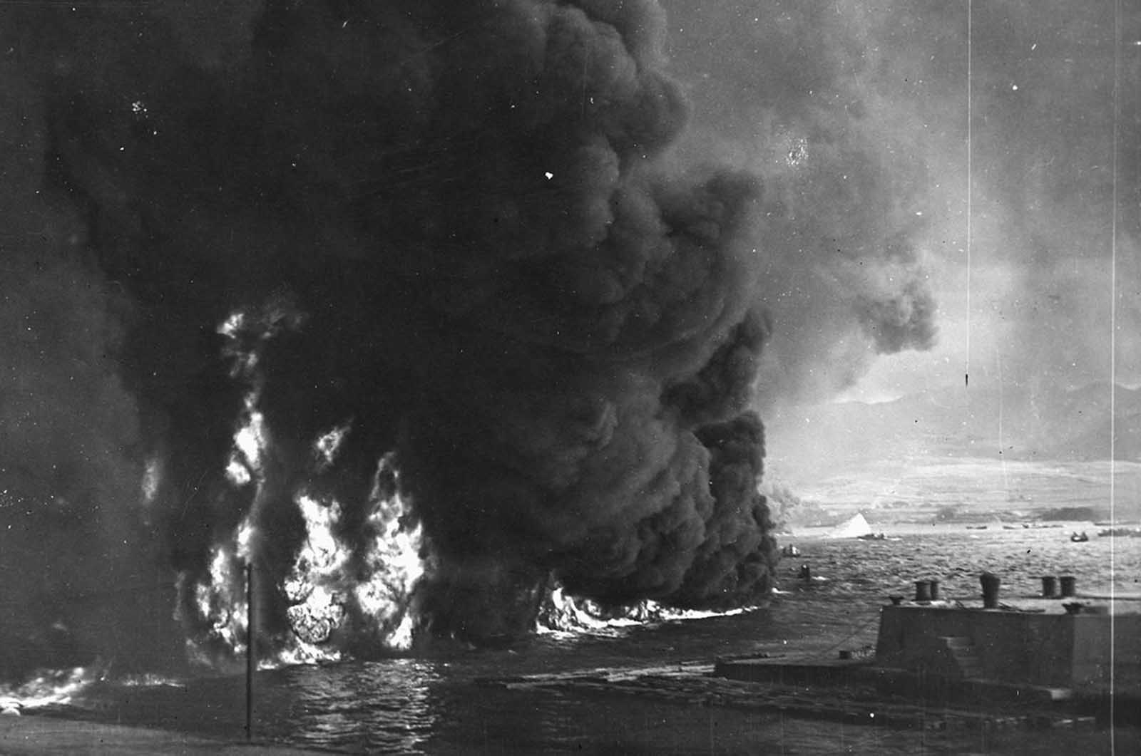 Oil burns on the waters of Pearl Harbor, near the naval air station, after the Japanese attack on Pearl Harbor on December 7, 1941.