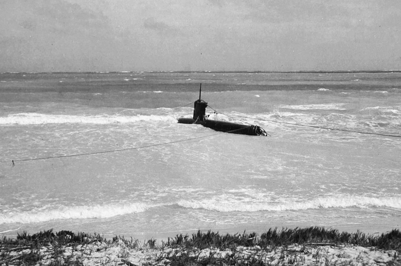 A Japanese midget submarine, part of the attacking force on Pearl Harbor, beached at Bellows Field.
