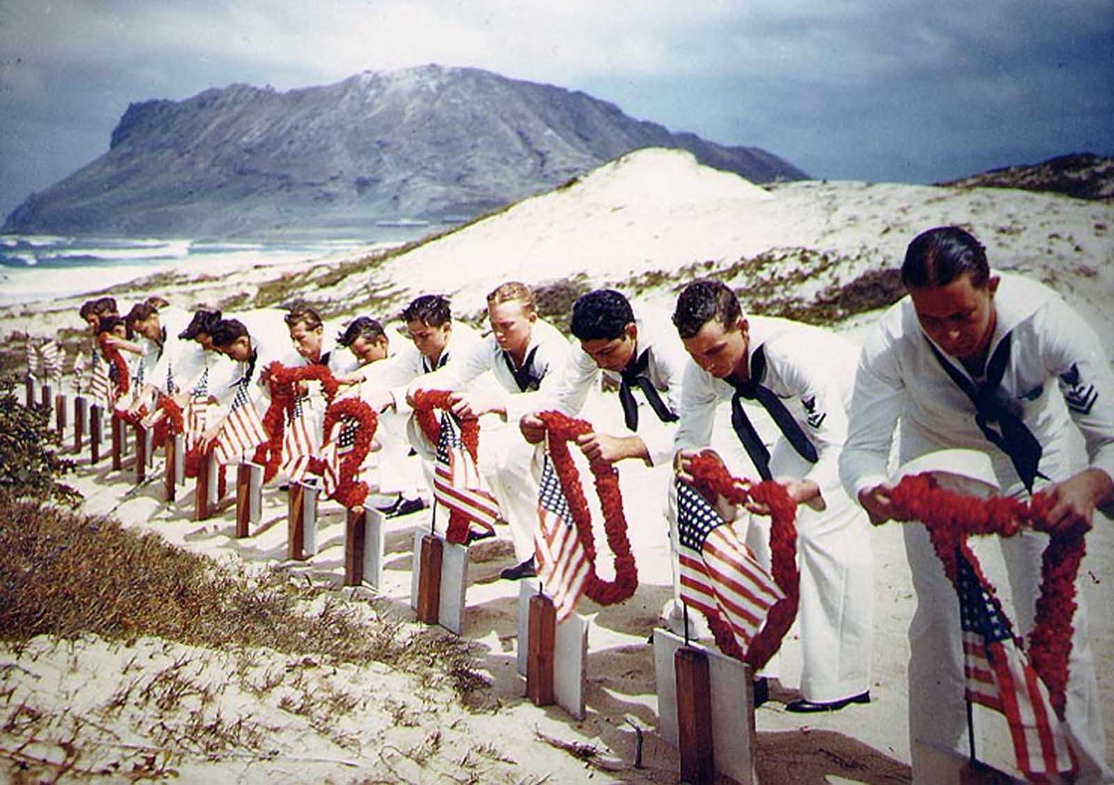 Following Hawaiian tradition, sailors honor men killed during the December 7, 1941, Japanese attack on Naval Air Station Kaneohe, Oahu. The casualties had been buried on December 8. This ceremony took place sometime during the following months.
