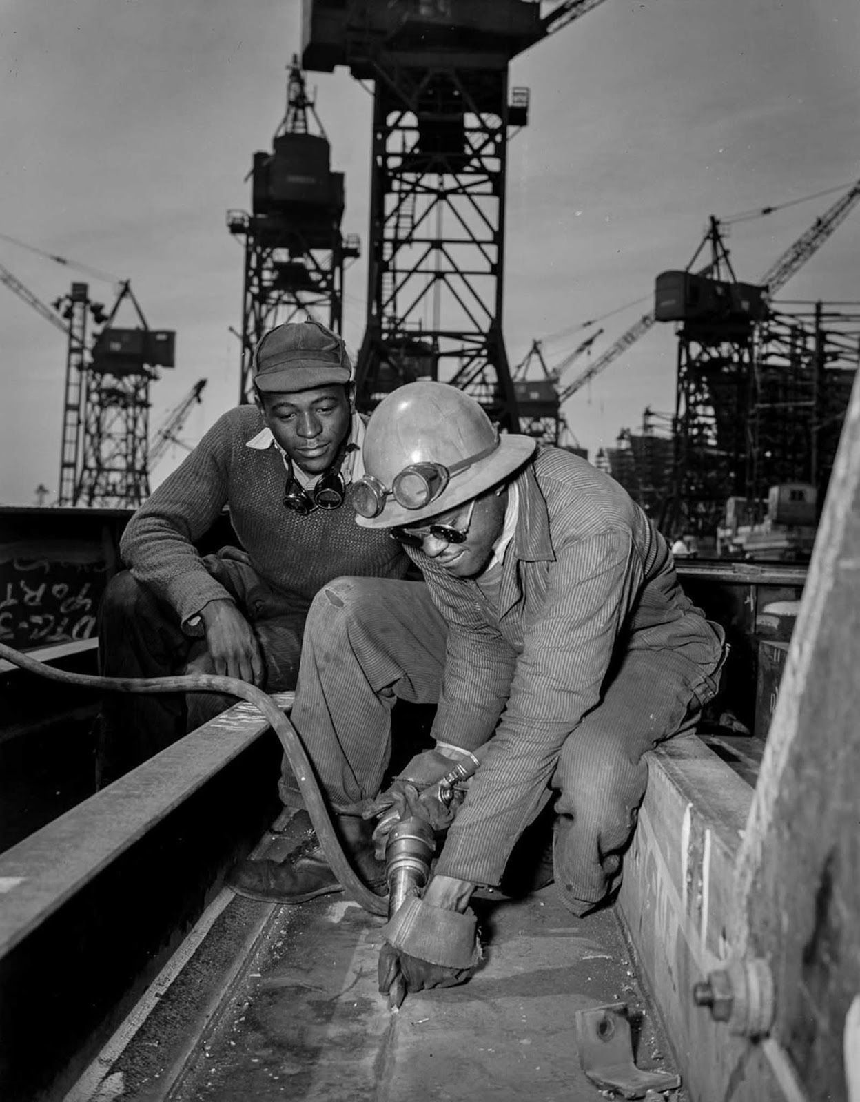 A chipper removes excess metal from a welded seam aboard the Liberty ship Frederick Douglass.