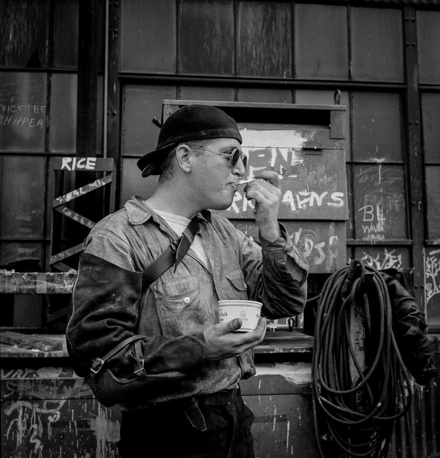 A welder enjoys some ice cream.
