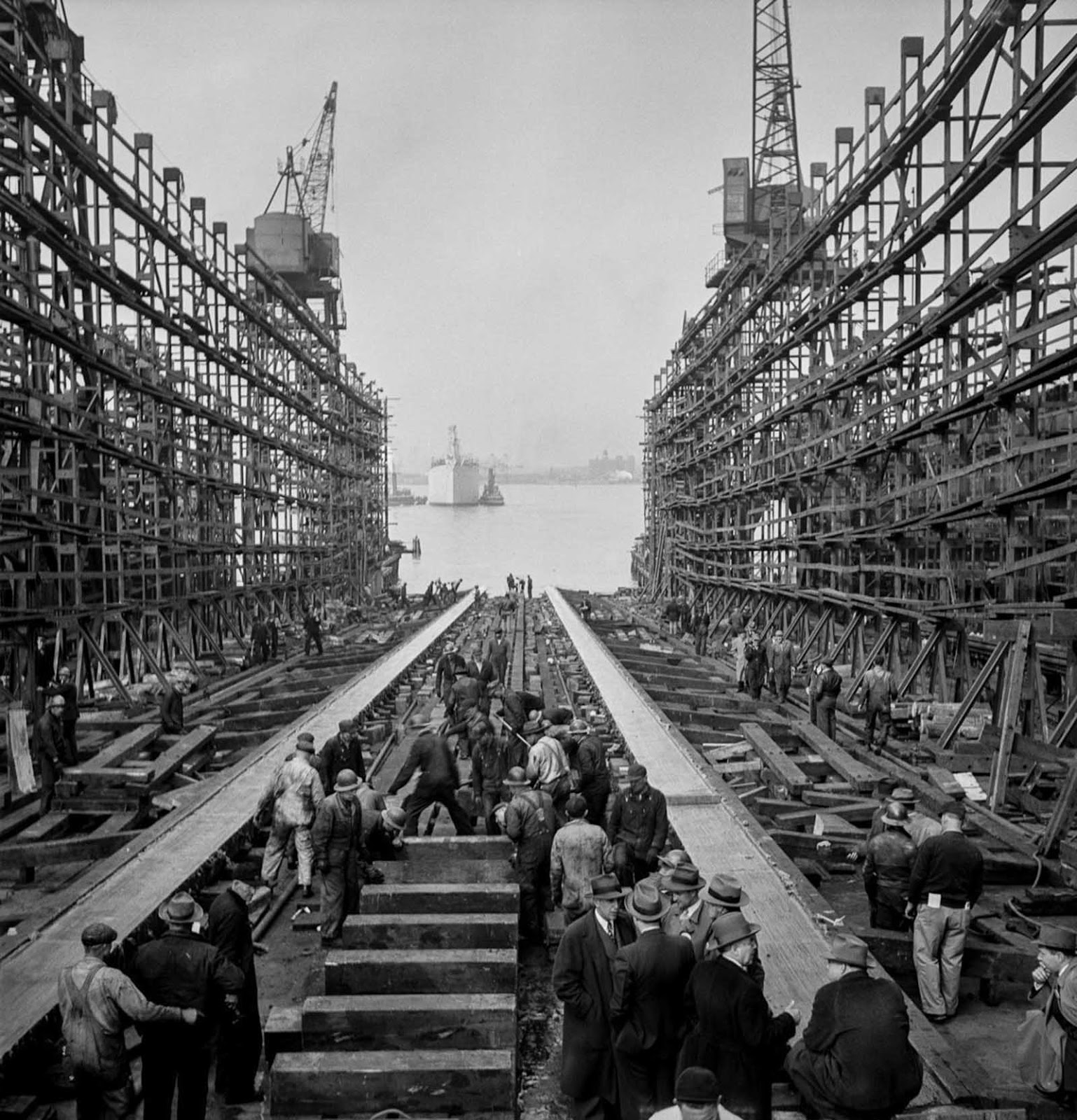 After a launch, workers fill the way and prepare to build another ship.