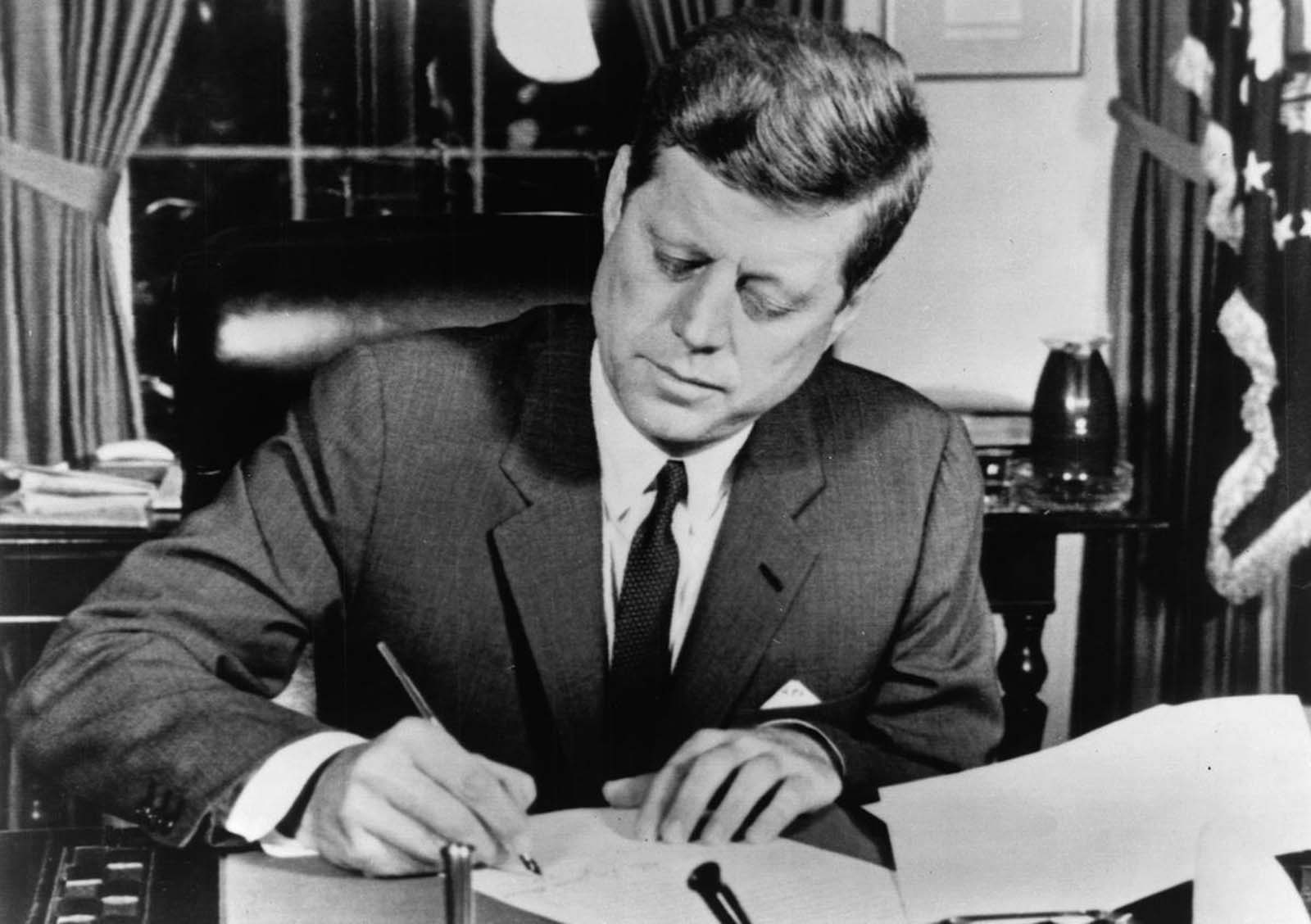 President John F. Kennedy signs a proclamation enacting the U.S. arms quarantine against Cuba, on October 23, 1962.