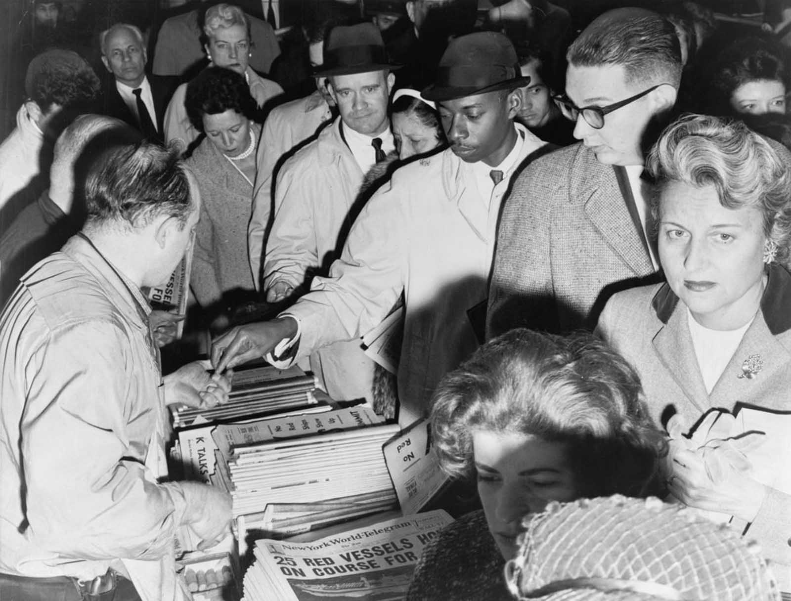 New Yorkers eager for news of the Cuban missile crisis line up to buy newspapers in October of 1962.