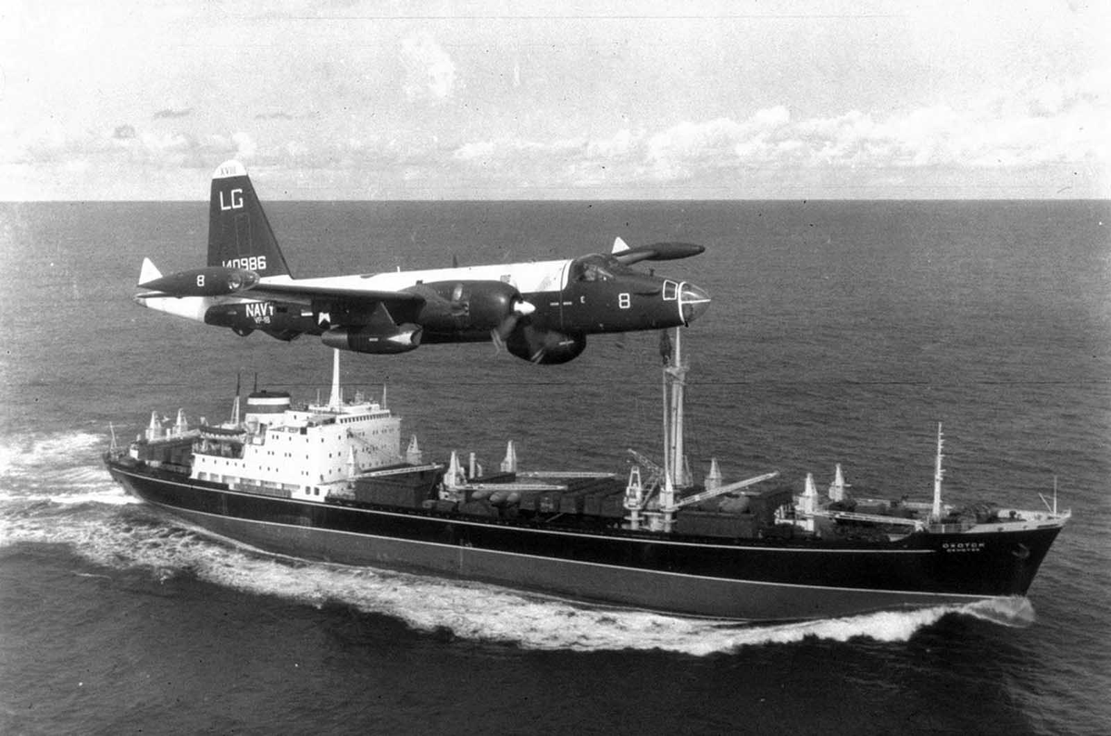 A P2V Neptune U.S. patrol plane flies over a Soviet freighter during the Cuban missile crisis in 1962.