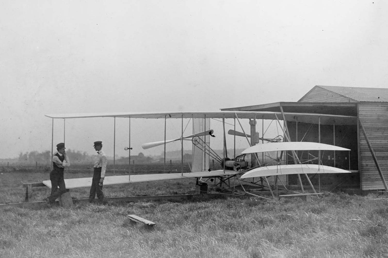 Wilbur and Orville Wright with their second powered machine on Huffman Prairie, near Dayton, Ohio, in May of 1904.