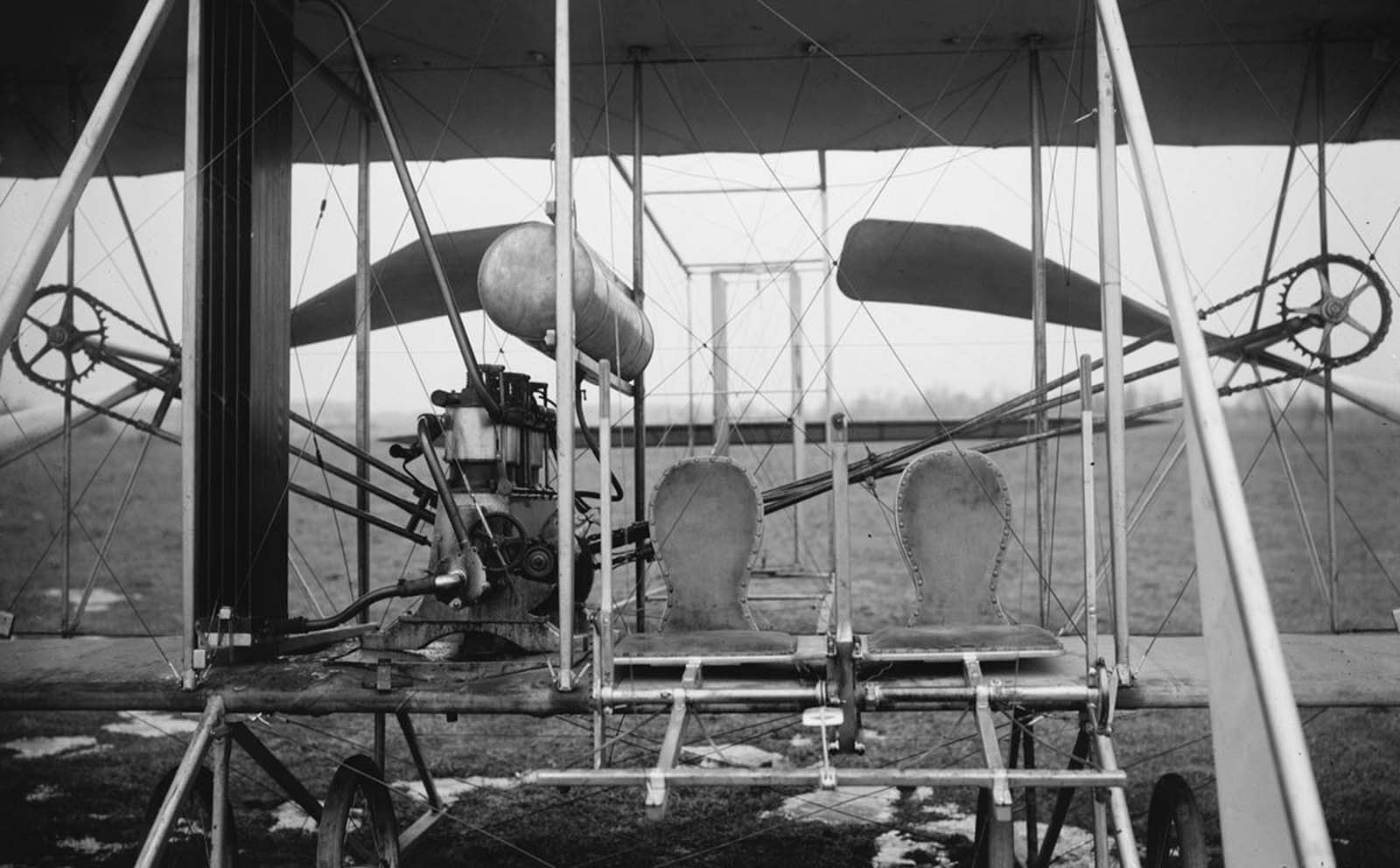 Close-up view of a Wright airplane, including the pilot and passenger seats, 1911.