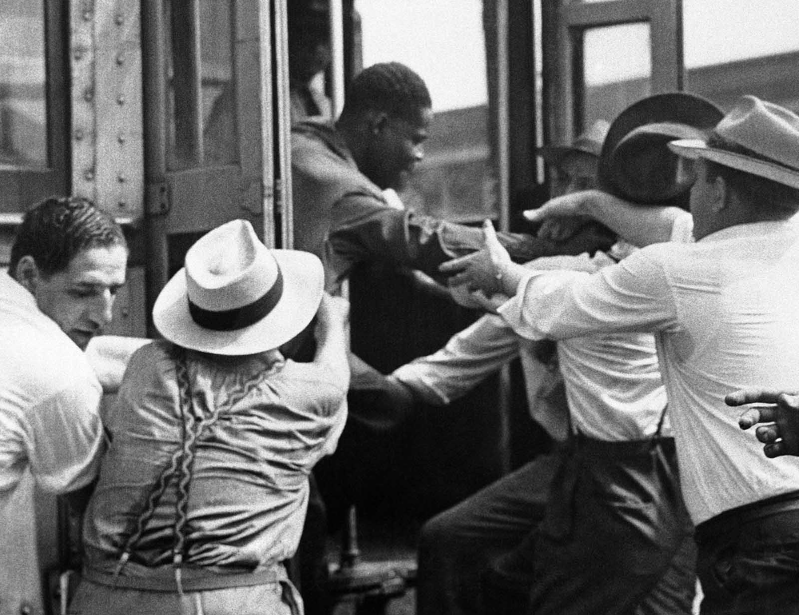 A man is dragged from a street car on June 21, 1943, during fighting near Detroit's downtown section.