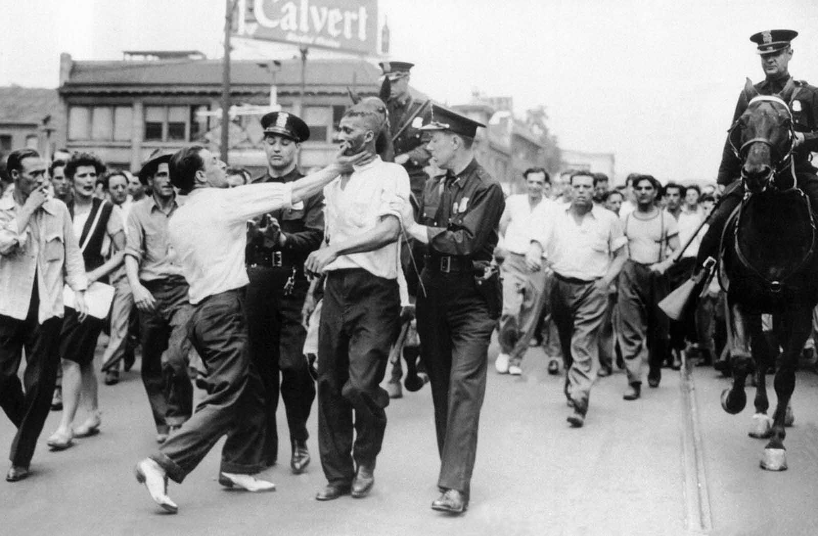 Police attempt to break up an incident as race rioting flared in the downtown area of Detroit on June 21, 1943. Troops were called in at the request of Michigan Governor Harry F. Kelly when police were unable to stop the fighting.