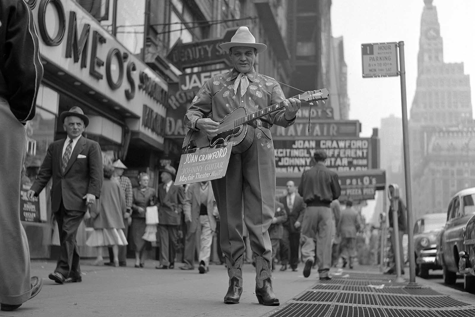 A man playing a guitar promotes the film 