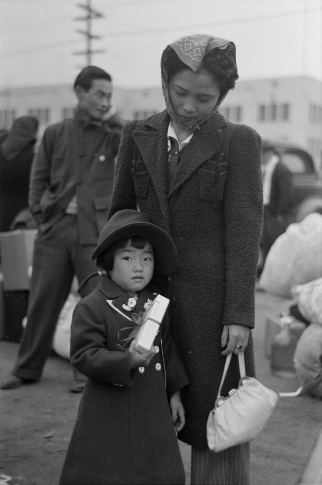 A mother and daughter assemble for relocation at a Los Angeles train station.