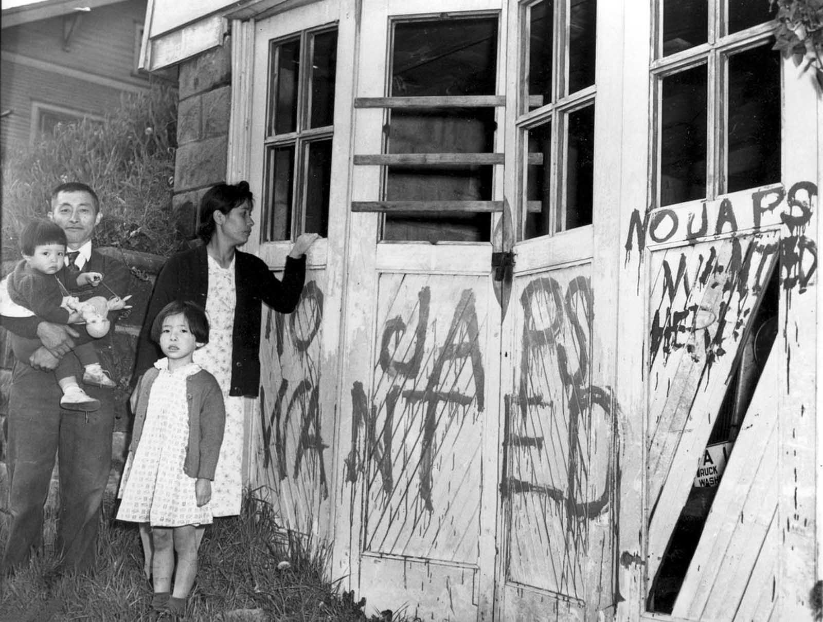 A Japanese family returning home from a relocation center camp in Hunt, Idaho, found their home and garage vandalized with anti-Japanese graffiti and broken windows in Seattle, Washington, on May 10, 1945.