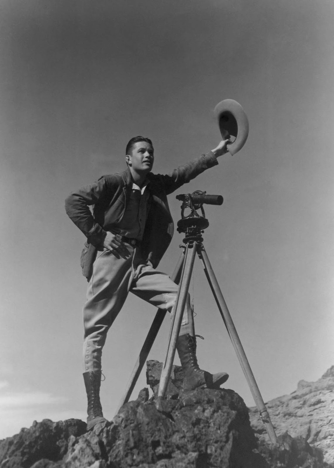 A surveyor signals to colleagues during the construction of the dam. 1932.