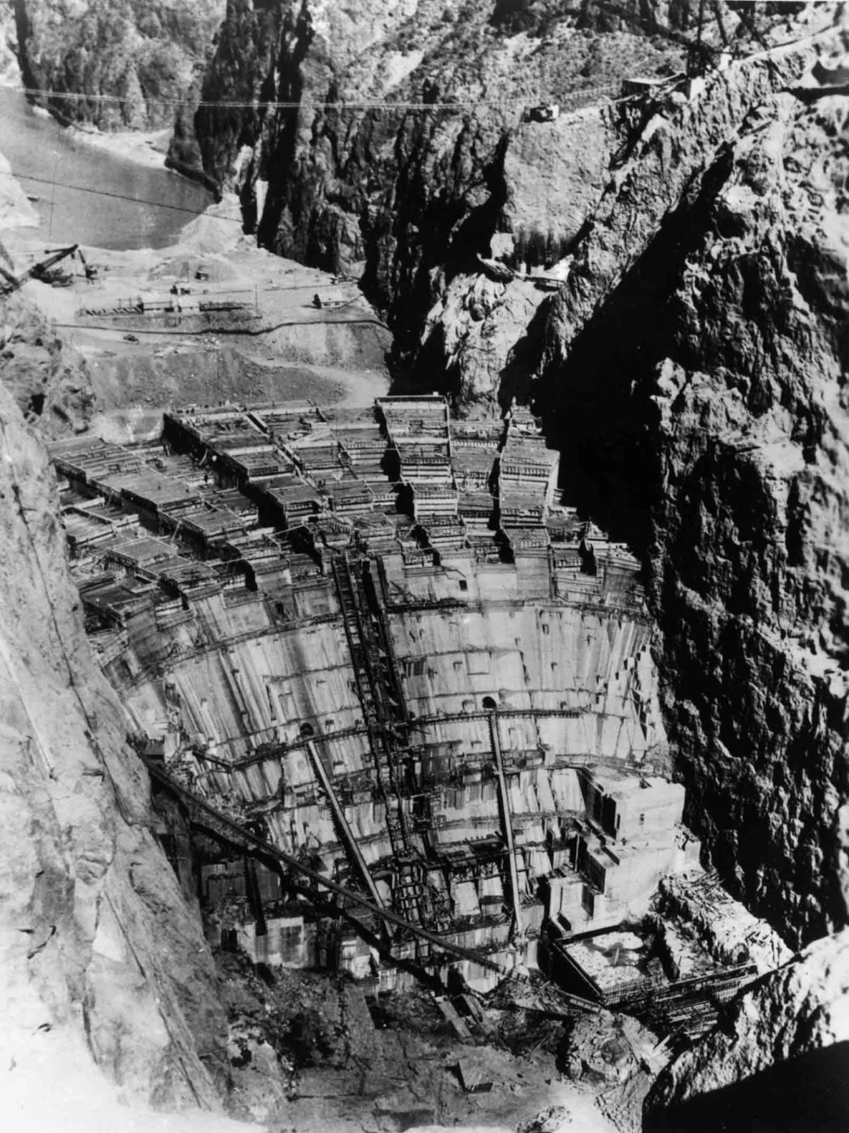 Since concrete heats and contracts as it cures, the potential for uneven cooling and contraction of the concrete posed a serious problem. Bureau of Reclamation engineers calculated that if the dam was built in a single continuous pour, the concrete would take 125 years to cool, and the resulting stresses would cause the dam to crack and crumble. Instead, the ground where the dam would rise was marked with rectangles, and concrete blocks in columns were poured, some as large as 50 ft square (15 m) and 5 feet (1.5 m) high.