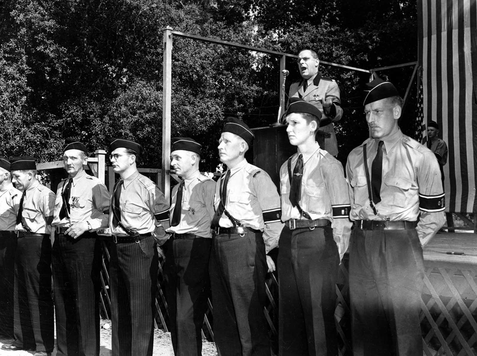 Members of the German-American Bund form a guard of honor before the speaker's stand as Fritz Kuhn, leader of the Bund, addresses a crowd at Hindenberg Park, La Crescenta, near Los Angeles, California, on April 30, 1939.