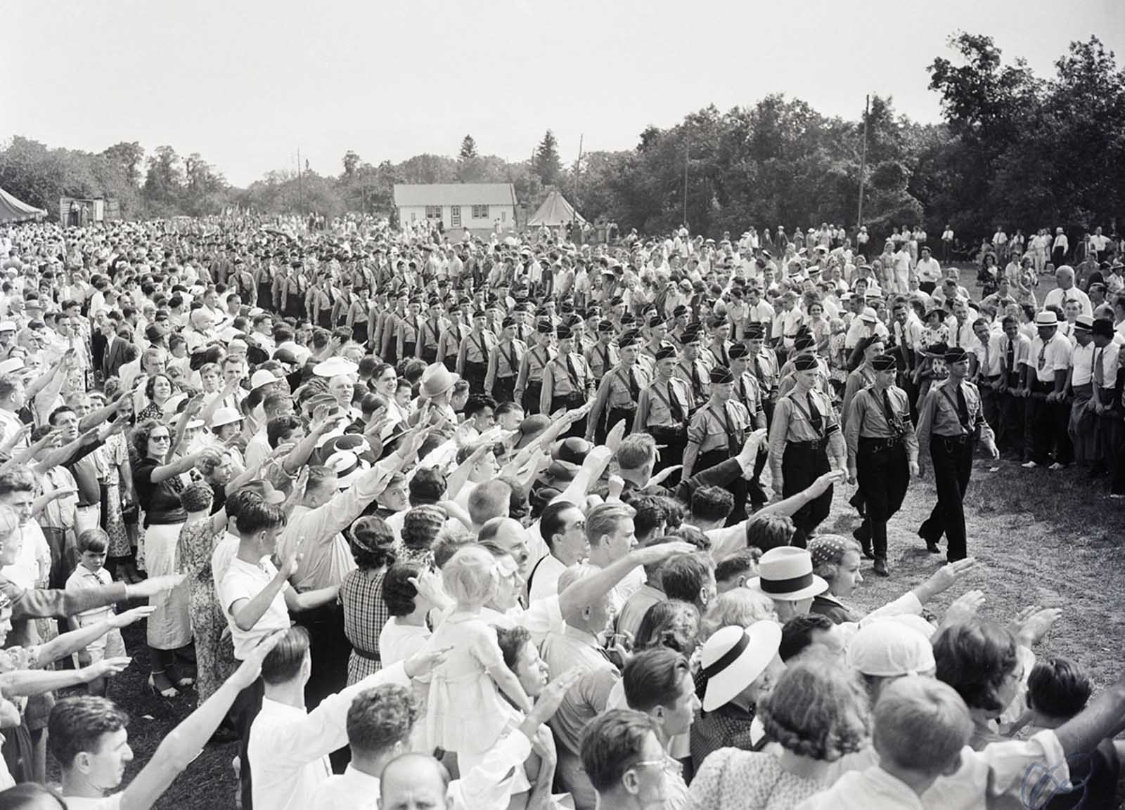 Hundreds of German Americans give the Nazi salute to young men marching in Nazi uniforms. The event was a German Day celebration sponsored by German American Bund at Camp Sigfried on Long Island.