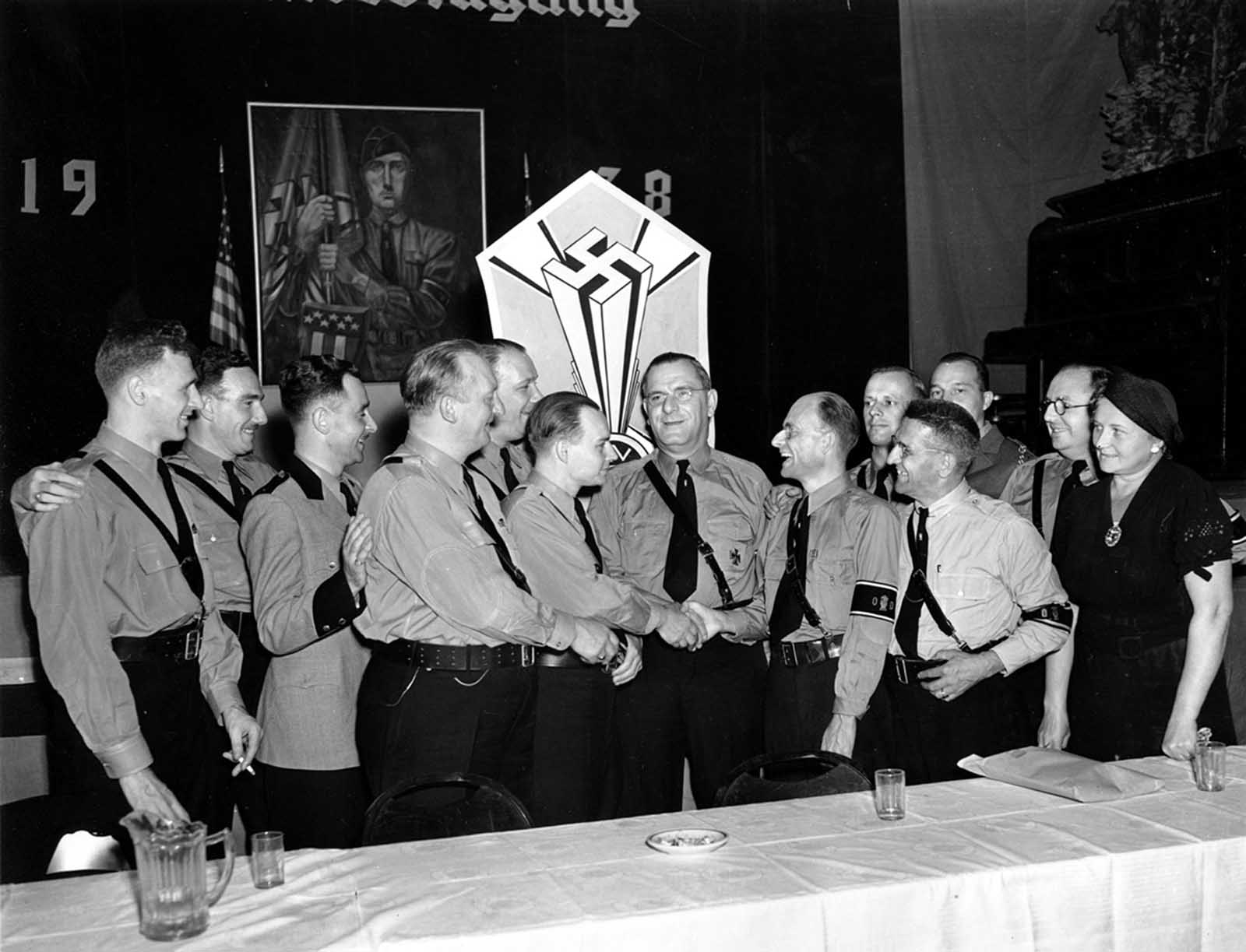 Fritz Kuhn, center facing forward, is congratulated by fellow officers of the German-American Bund in New York on September 4, 1938. Kuhn was unanimously re-elected on September 3 as National leader of the Bund, a pro-Nazi organization holding its sixth annual convention.