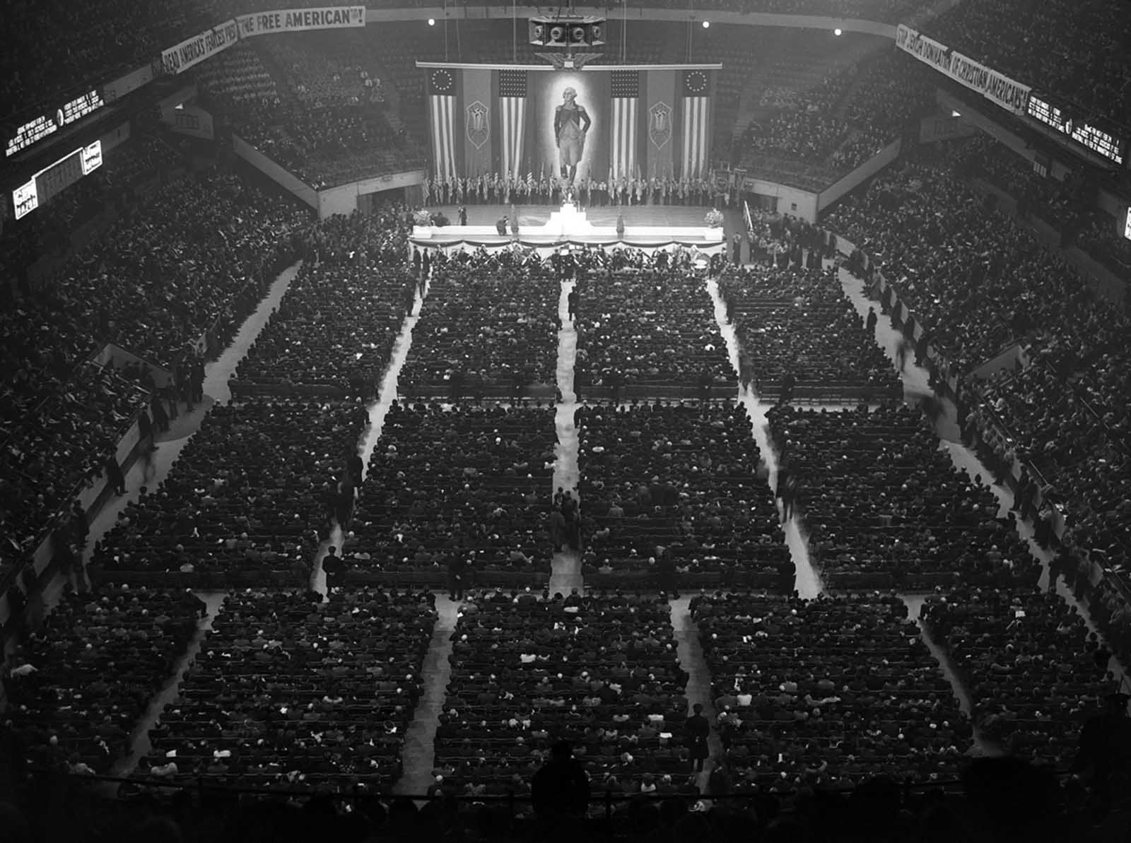 A crowd of approximately 20,000 attends a German American Bund Rally at New York's Madison Square Garden on February 20, 1939. At center is a large portrait of George Washington, claimed as an icon by the Bund, who called him
