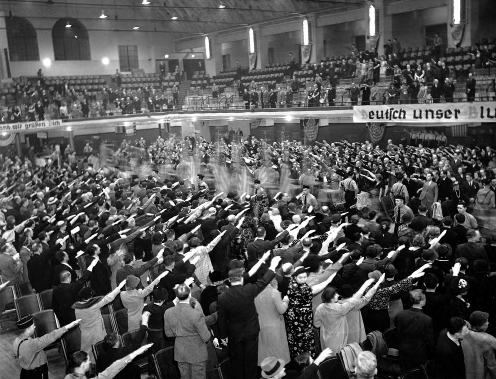 Pro-Nazi members of various singing and gymnastic societies salute a procession of flags at White Plains Hall in New York in the 1930s. They were gathered for a German Day celebration. The German-American Bund disclaimed this large group